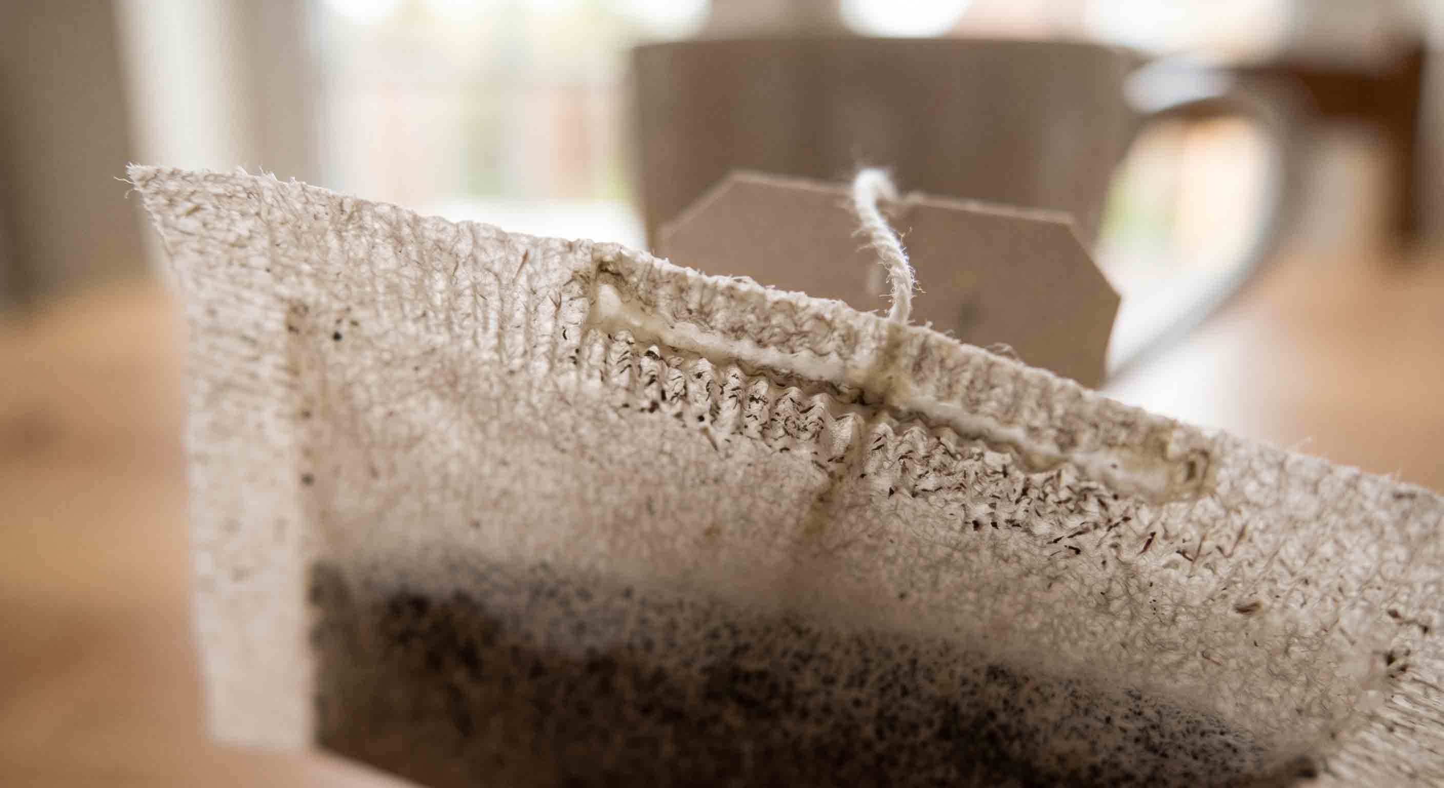 Macro shot of a traditional paper tea bag's thick glued seam
