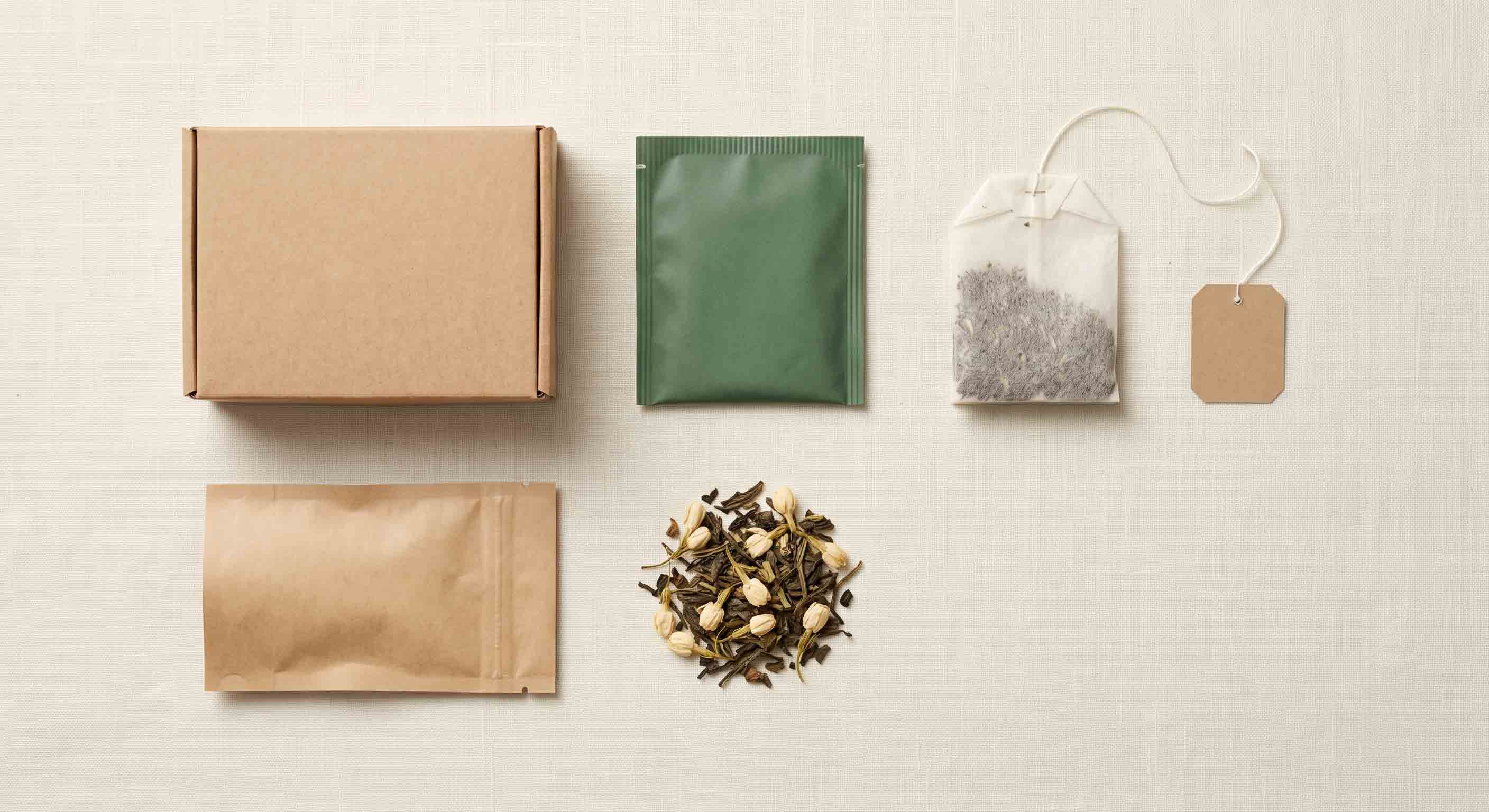 Article summary visual of separate unbranded tea packaging components.
